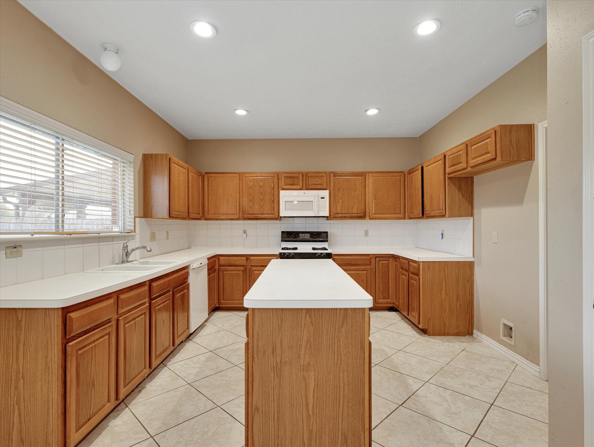 16423 Ash Point Lane Sugar Land, TX 77498 - Photo 15 of 46 a kitchen with stainless steel appliances granite countertop a sink counter space cabinets and a large window