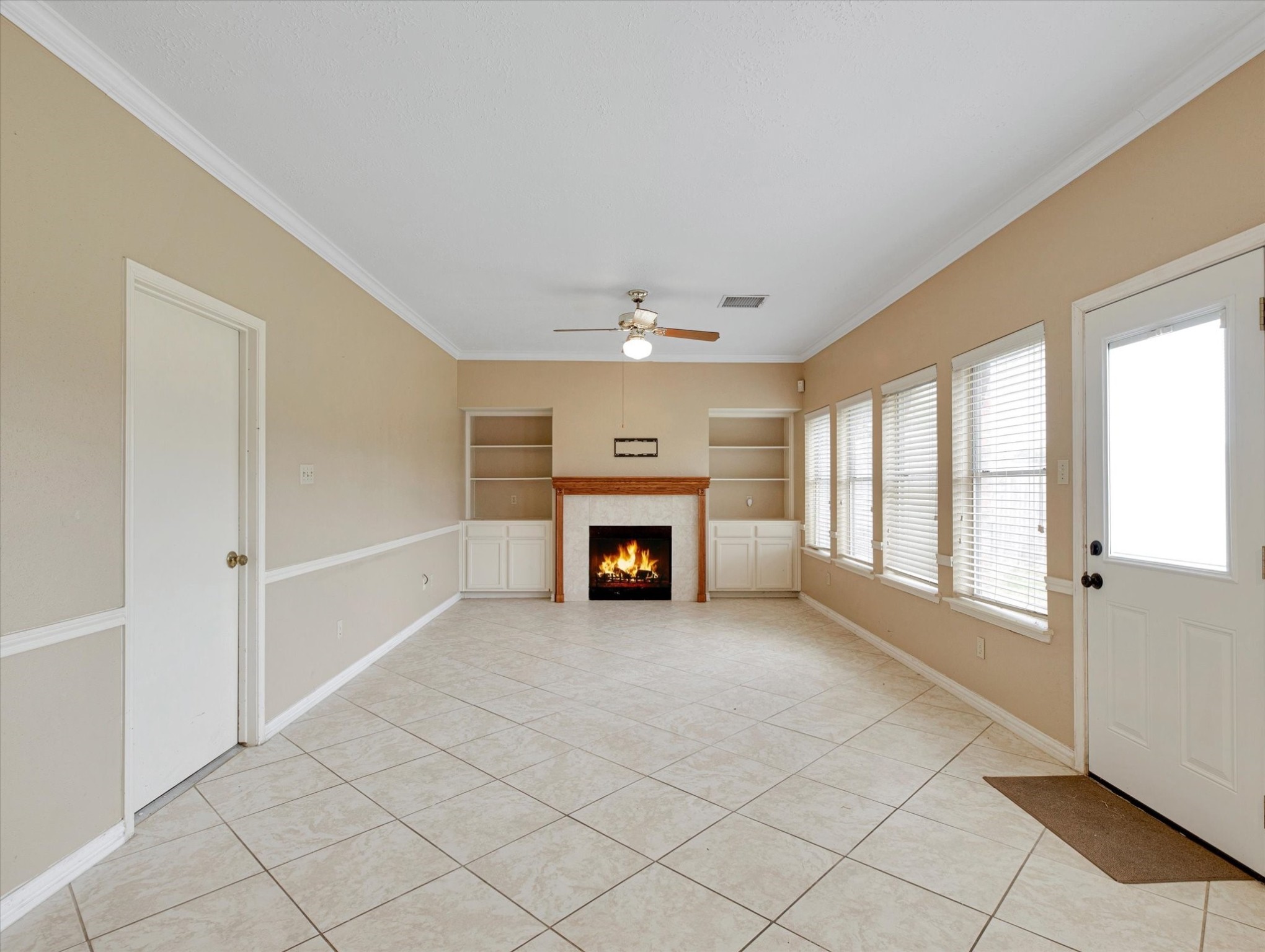 16423 Ash Point Lane Sugar Land, TX 77498 - Photo 17 of 46 an empty room with windows and fireplace