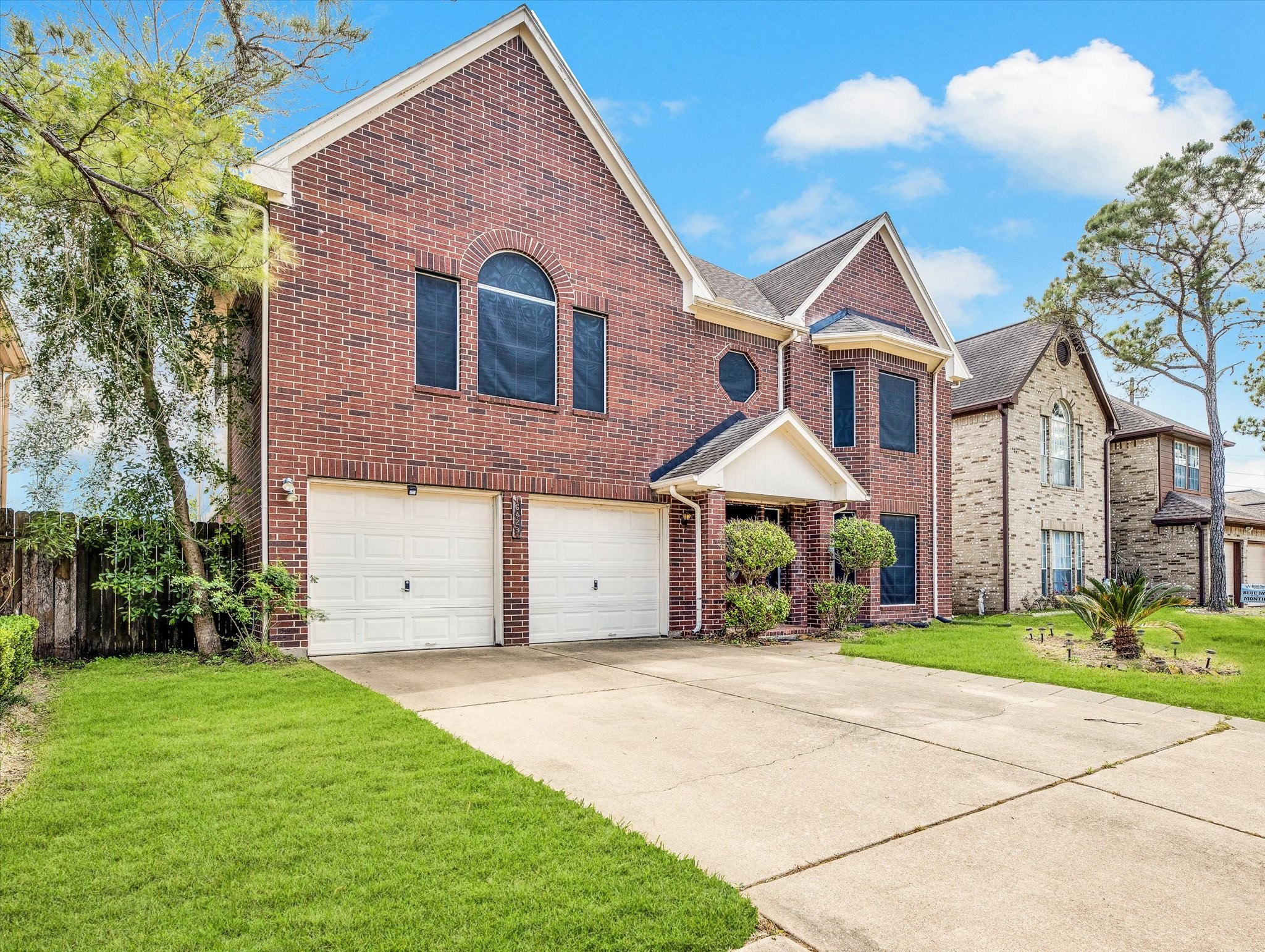 16423 Ash Point Lane Sugar Land, TX 77498 - Photo 2 of 46 a front view of a house with a yard and garage