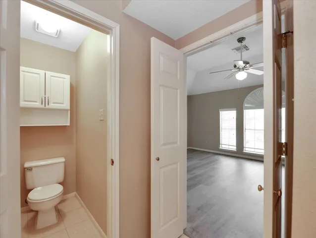 wooden floor in an empty room with a ceiling fan
