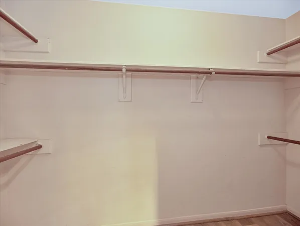 wooden floor in an empty room with a ceiling fan
