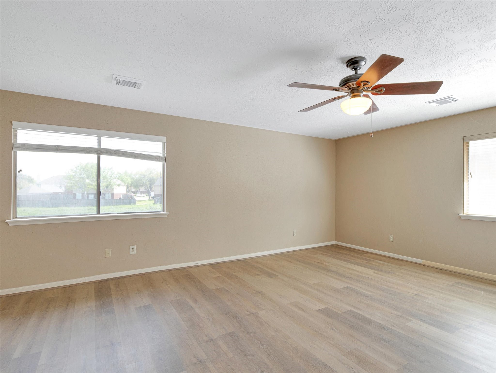 16423 Ash Point Lane Sugar Land, TX 77498 - Photo 36 of 46 a view of empty room with wooden floor and fan