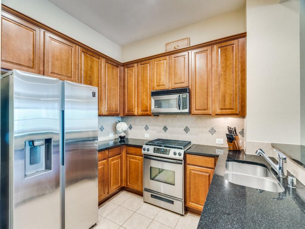 15711 Spectrum Drive, Unit 80 Addison, TX 75001 - Photo 14 of 26 a kitchen with a sink stove and refrigerator