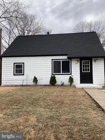 a house that has a tree in front of it