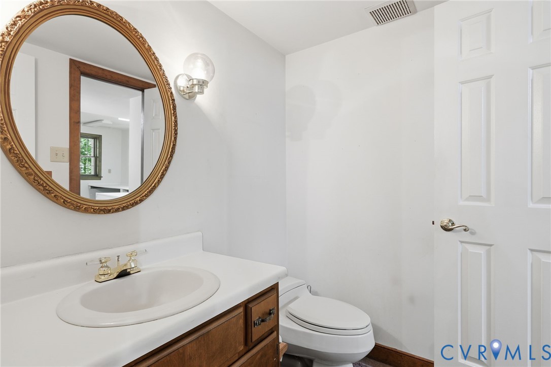 3201 East Brigstock Road Midlothian, VA 23113 - Photo 26 of 72 a bathroom with a sink a toilet and a mirror