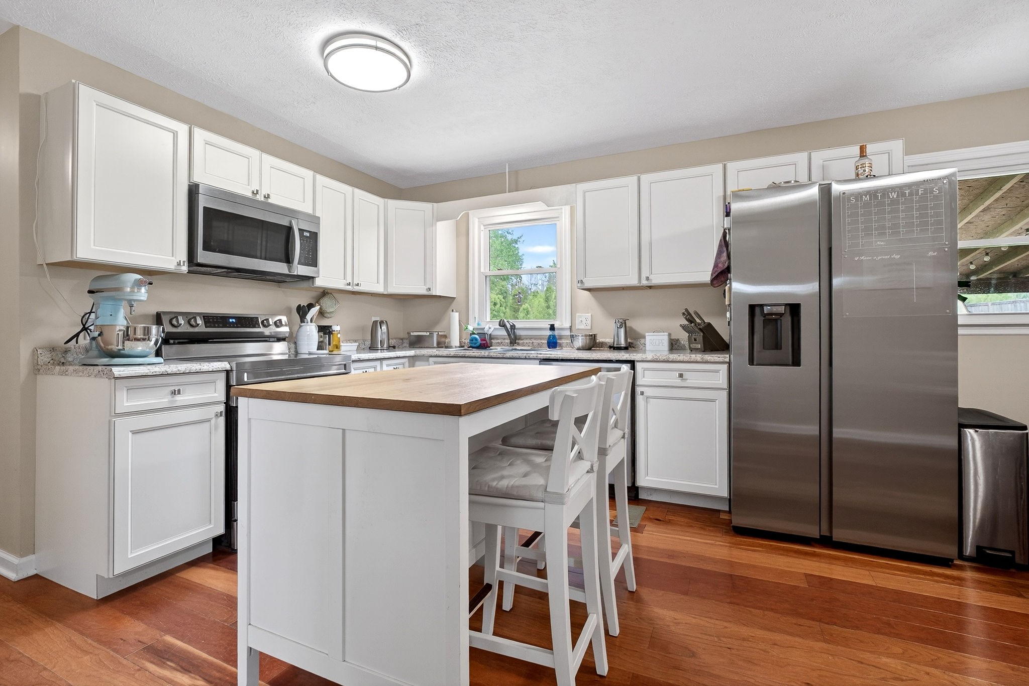 237 Armstrong Road Doyle, TN 38559 - Photo 9 of 34 a kitchen with a refrigerator a microwave a sink and cabinets