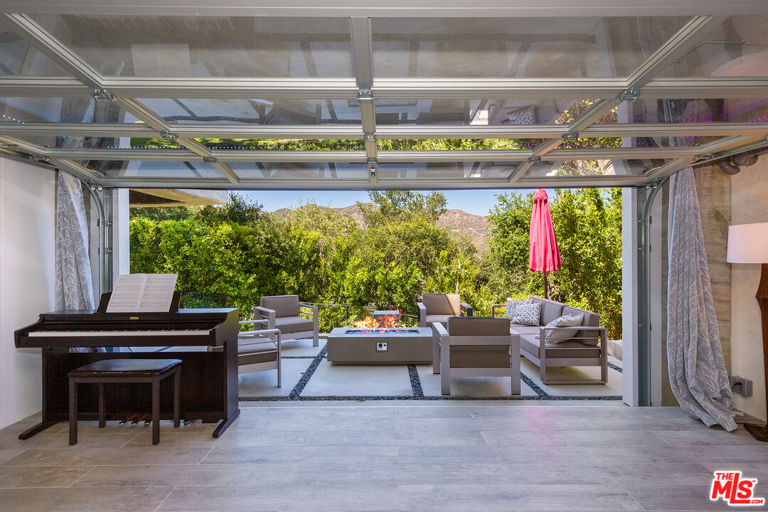 26227 Fairside Road Malibu, CA 90265 - Photo 23 of 30 a outdoor living space with furniture and a fireplace