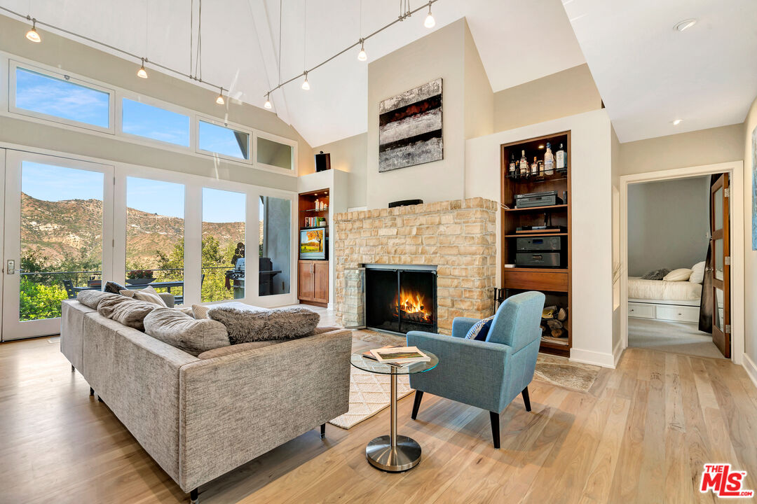 26227 Fairside Road Malibu, CA 90265 - Photo 3 of 30 a living room with furniture and a fireplace