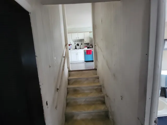 a view of staircase with white walls