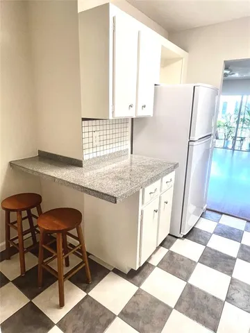 a kitchen with stainless steel appliances granite countertop a sink and a refrigerator