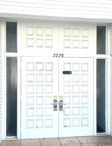 a building outdoor space with patio furniture and garden