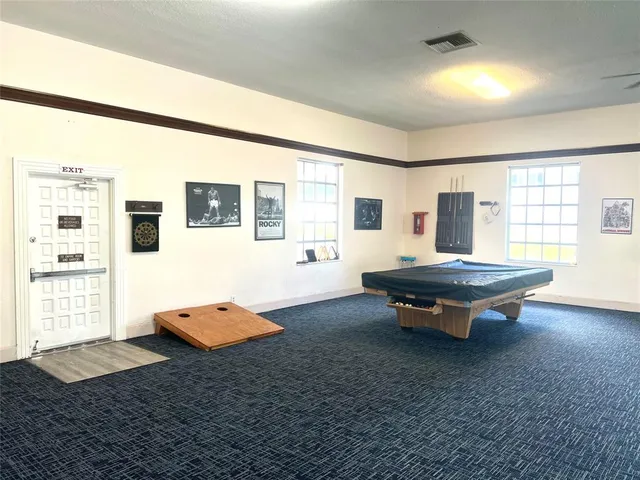a living room with fireplace furniture and a table