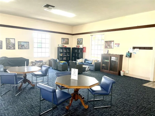 a view of a patio with table and chairs and potted plants