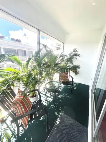 a vase of flowers sitting on a table in front of a window