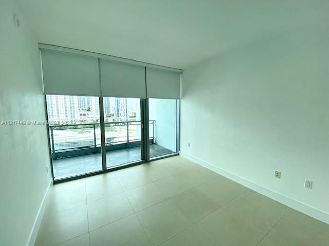 92 Southwest 3rd Street, Unit 1412 Miami, FL 33130 - Photo 11 of 37 an empty room with sliding glass door