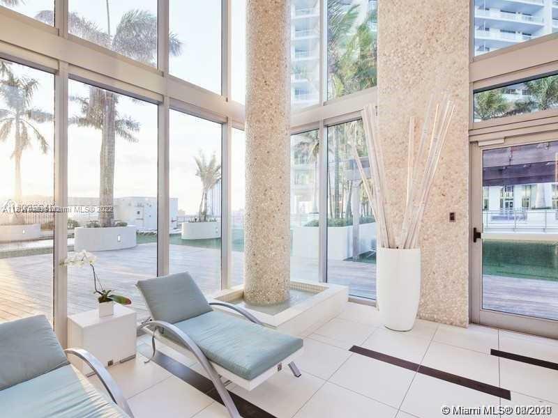 92 Southwest 3rd Street, Unit 1412 Miami, FL 33130 - Photo 26 of 37 a living room with furniture and a floor to ceiling window