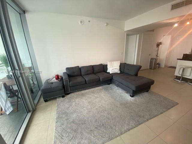 92 Southwest 3rd Street, Unit 1412 Miami, FL 33130 - Photo 3 of 37 a living room with furniture and a couch