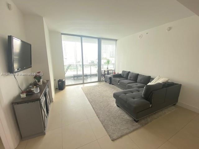 92 Southwest 3rd Street, Unit 1412 Miami, FL 33130 - Photo 4 of 37 a living room with furniture and a flat screen tv