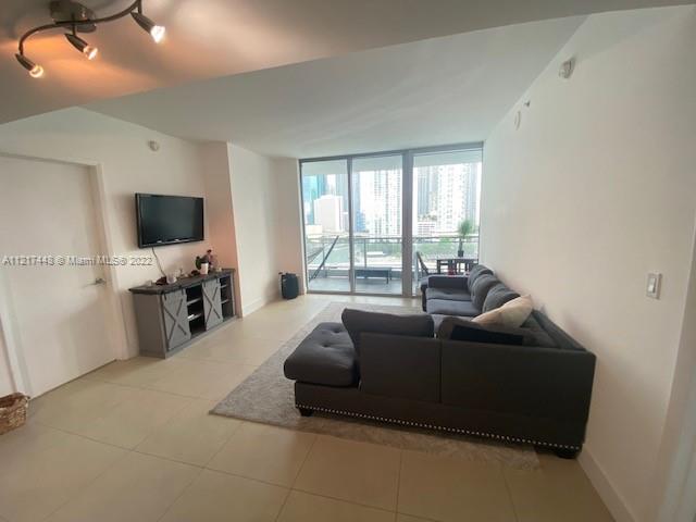 92 Southwest 3rd Street, Unit 1412 Miami, FL 33130 - Photo 5 of 37 a living room with furniture and a flat screen tv