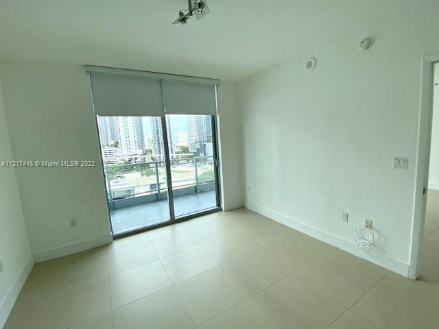 92 Southwest 3rd Street, Unit 1412 Miami, FL 33130 - Photo 7 of 37 an empty room with sliding glass door