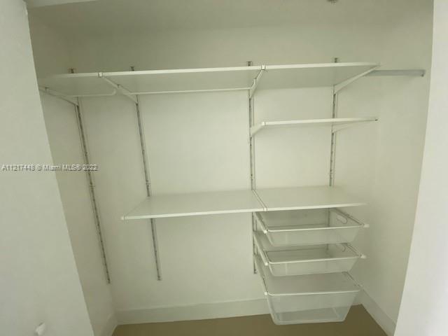 92 Southwest 3rd Street, Unit 1412 Miami, FL 33130 - Photo 9 of 37 a view of walk in closet with empty racks