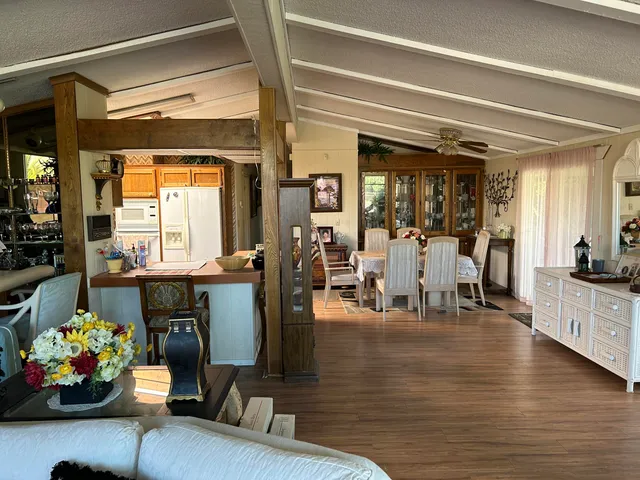 a kitchen with stainless steel appliances granite countertop a stove a sink dishwasher and cabinets with wooden floor