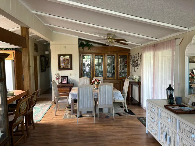 a kitchen that has a lot of cabinets and wooden floor