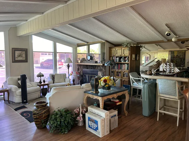 a room with stainless steel appliances kitchen island granite countertop furniture and a fireplace
