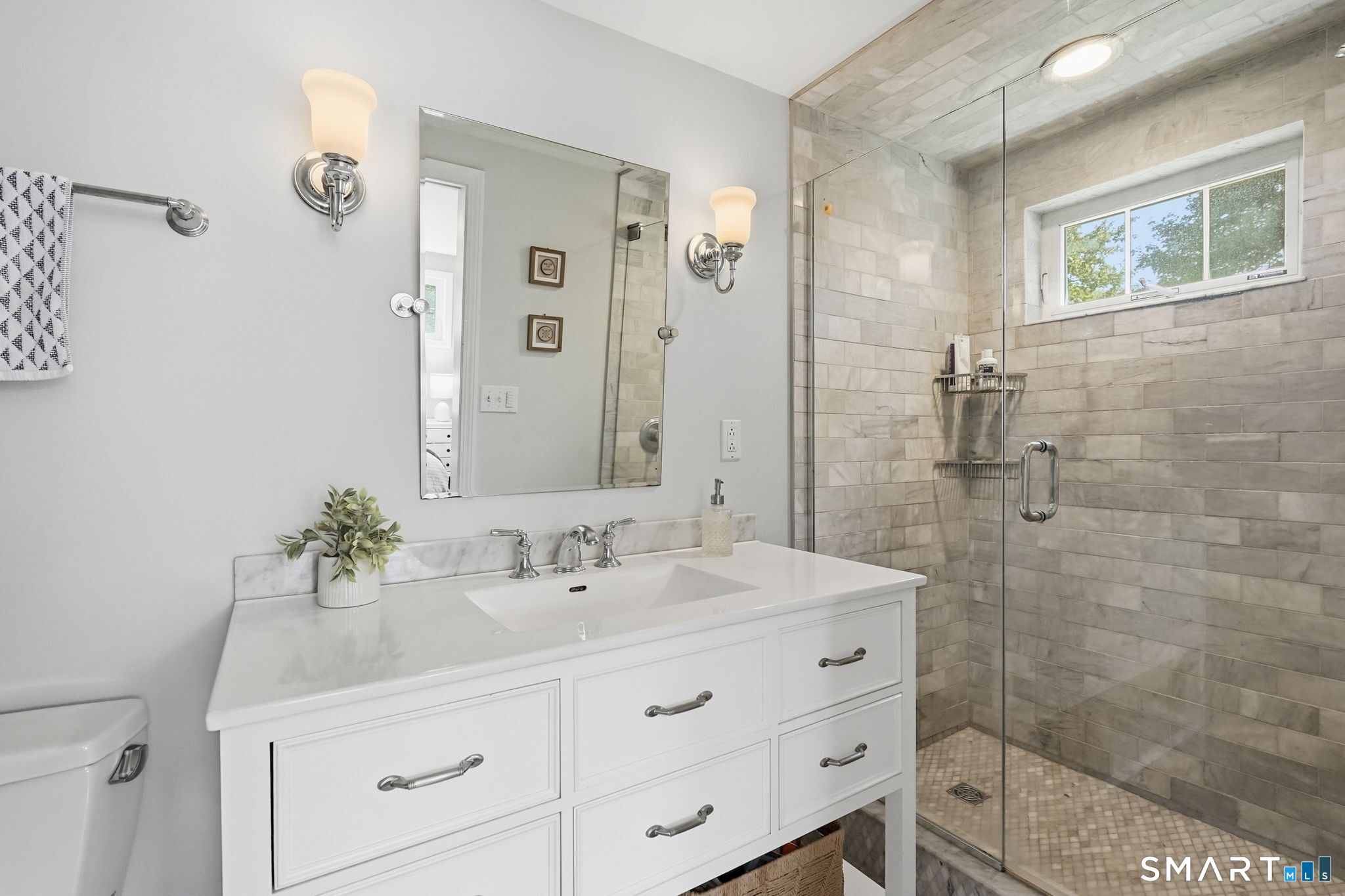 6 Cornfield Road Simsbury, CT 06070 - Photo 22 of 40 The primary bathroom features a white vanity and a large marble tiled shower and floor.
