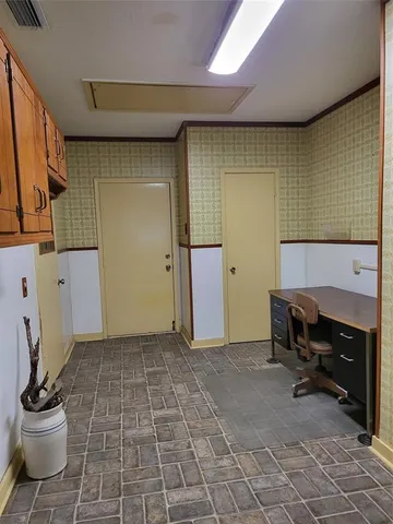 a view of a pathway of a house with potted plants