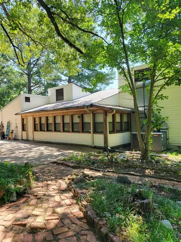 a backyard of a house with a tree