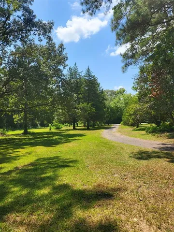 a view of swimming pool is middle in the garden