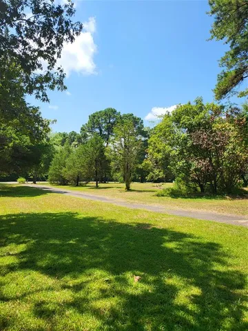 a view of a house with backyard porch and sitting area