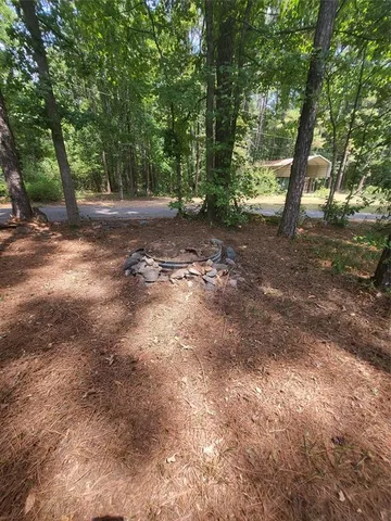 a backyard of a house with a yard and outdoor seating