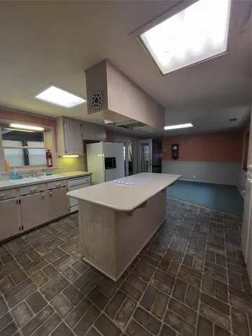 a kitchen with stainless steel appliances a sink stove and cabinets