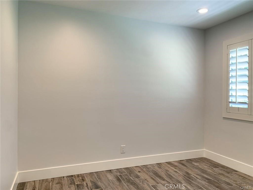16264 Sierra Ridge Way Hacienda Heights, CA 91745 - Photo 13 of 14 an empty room with wooden floor and windows