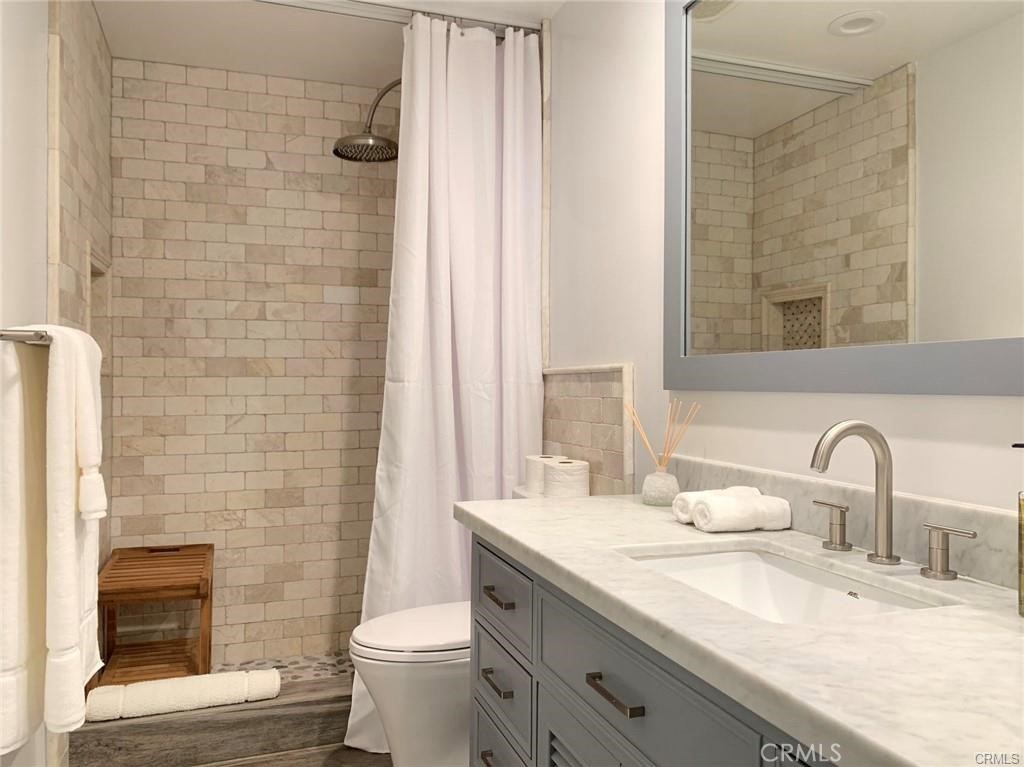 16264 Sierra Ridge Way Hacienda Heights, CA 91745 - Photo 14 of 14 a bathroom with a granite countertop toilet a sink and a mirror