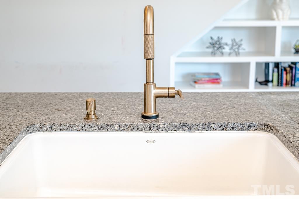6712 Lucado Court Raleigh, NC 27603 - Photo 12 of 52 a bathroom with a granite countertop sink and a mirror