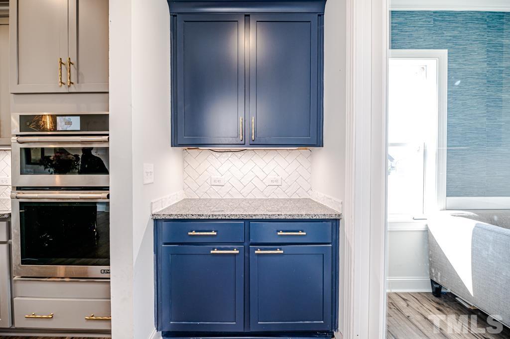 6712 Lucado Court Raleigh, NC 27603 - Photo 14 of 52 a kitchen with granite countertop cabinets and steel stainless steel appliances