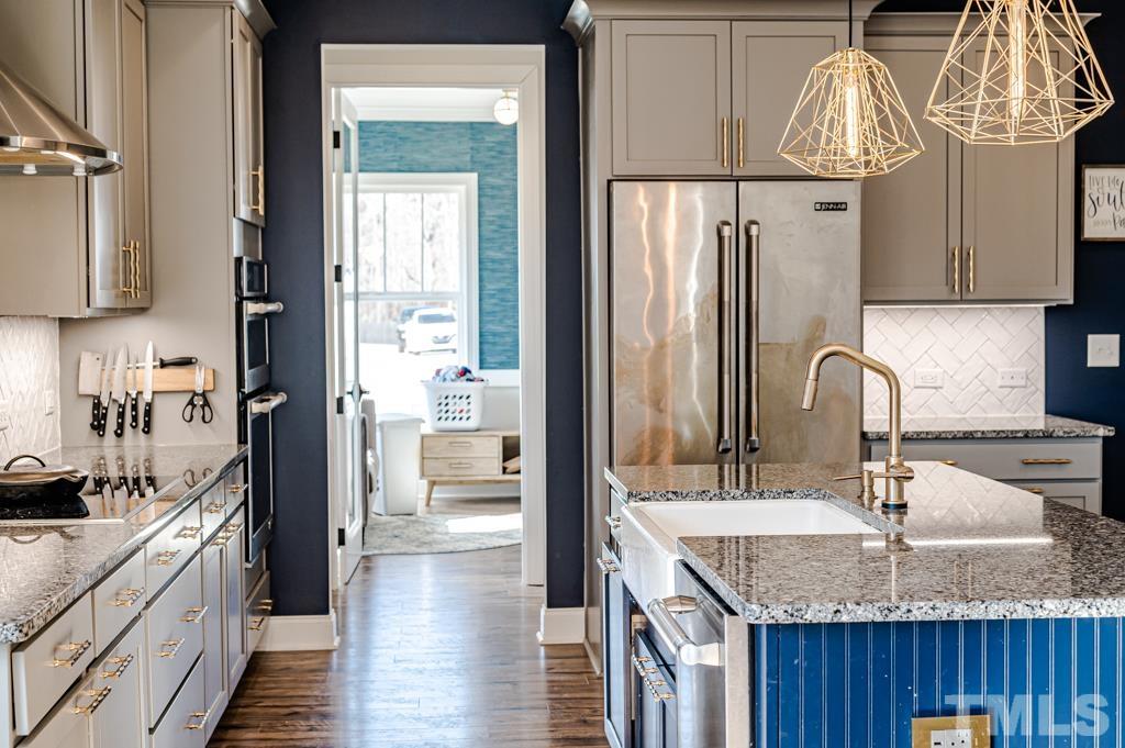 6712 Lucado Court Raleigh, NC 27603 - Photo 15 of 52 a kitchen with granite countertop a sink and a refrigerator