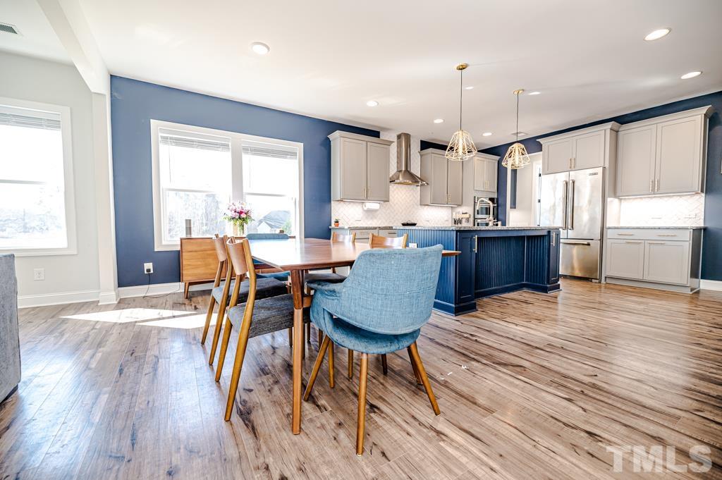 6712 Lucado Court Raleigh, NC 27603 - Photo 17 of 52 a view of a dining room with furniture window and wooden floor