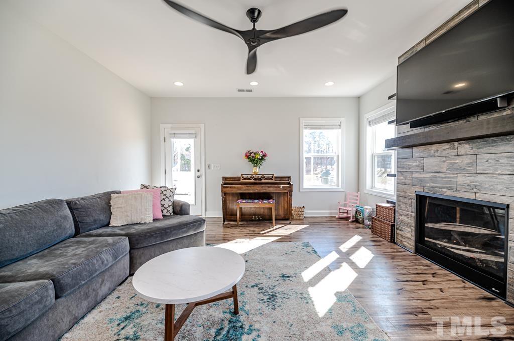 6712 Lucado Court Raleigh, NC 27603 - Photo 19 of 52 a living room with furniture and a fireplace