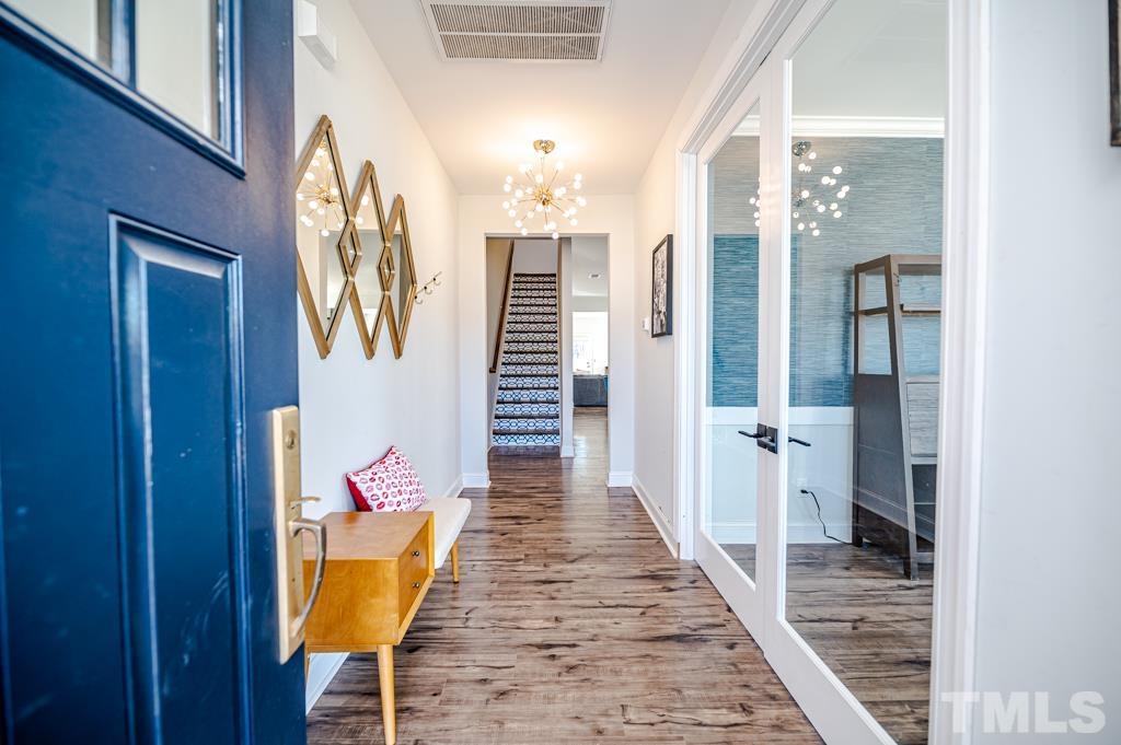 6712 Lucado Court Raleigh, NC 27603 - Photo 2 of 52 a view of a hallway with wooden floor and staircase