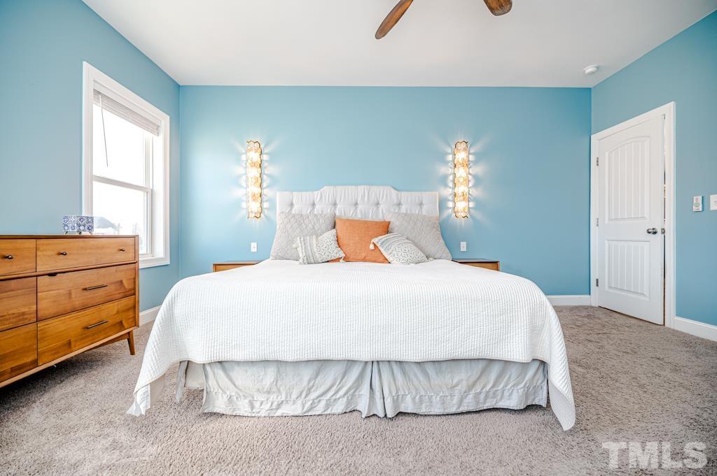 6712 Lucado Court Raleigh, NC 27603 - Photo 24 of 52 a bedroom with a bed and window