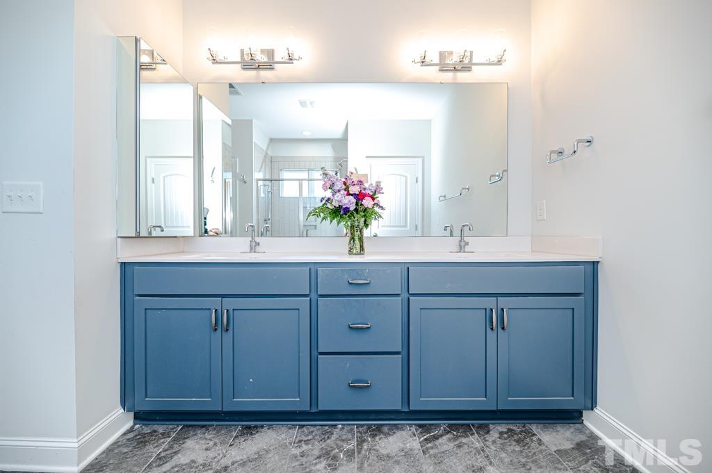 6712 Lucado Court Raleigh, NC 27603 - Photo 26 of 52 a bathroom with a sink vanity granite and a mirror