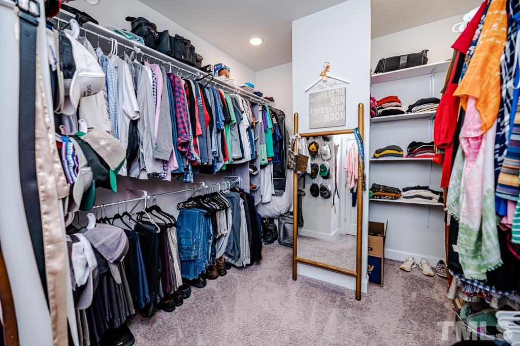 6712 Lucado Court Raleigh, NC 27603 - Photo 28 of 52 a view of walk in closet with clothes and shoes