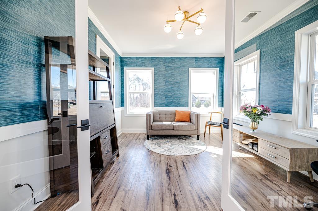 6712 Lucado Court Raleigh, NC 27603 - Photo 3 of 52 a living room with furniture and wooden floor