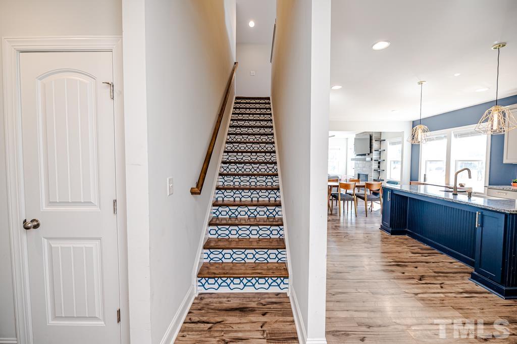 6712 Lucado Court Raleigh, NC 27603 - Photo 34 of 52 a room with lots of white furniture and wooden floor