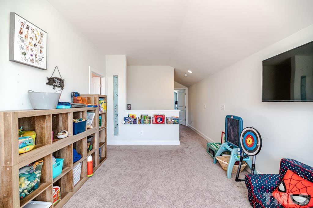 6712 Lucado Court Raleigh, NC 27603 - Photo 35 of 52 a view of play room with toys and book shelf