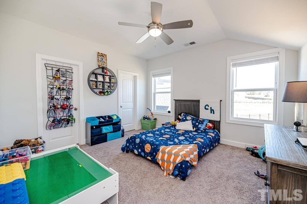 6712 Lucado Court Raleigh, NC 27603 - Photo 39 of 52 a bedroom with two beds and a chair